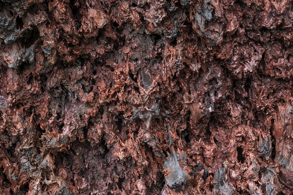 Solidified reddish lava at the volcano Piton de la Fournaise