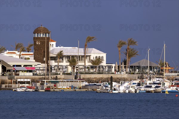 Marina and sidewalk cafe in El Castillo or Caleta de Fuste