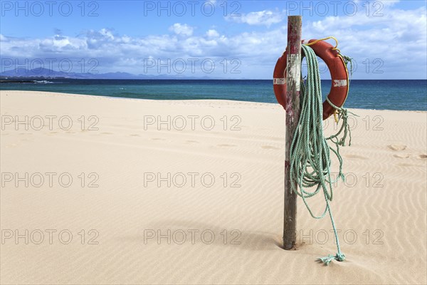 Lifebuoy on the sandy beach Playa Bajo Negro