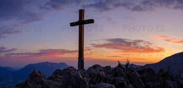 Summit cross in red sky