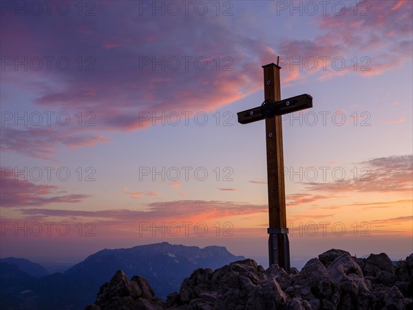 Summit cross in red sky