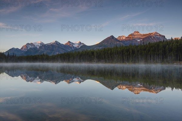 The Bow Range reflected in Herbert Lake at dawn