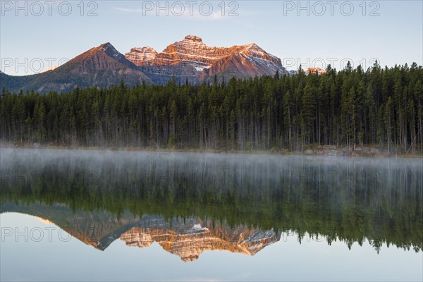 The Bow Range reflected in Herbert Lake at dawn