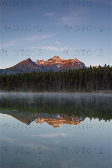 The Bow Range reflected in Herbert Lake at dawn