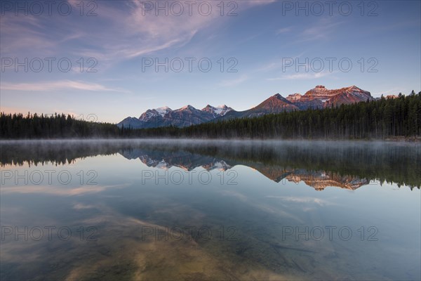 The Bow Range reflected in Herbert Lake at dawn