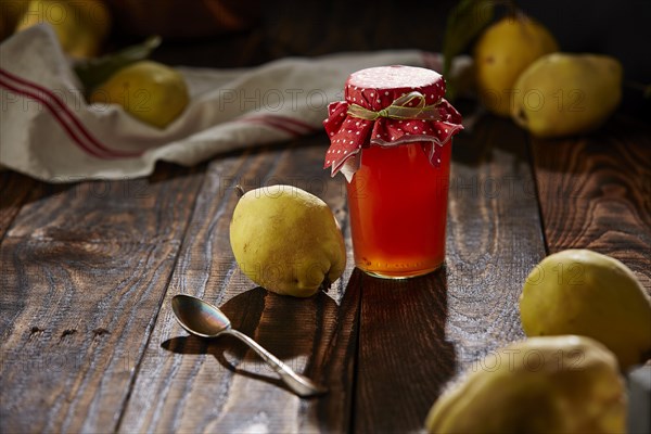 Quince jelly and fruit on wooden table