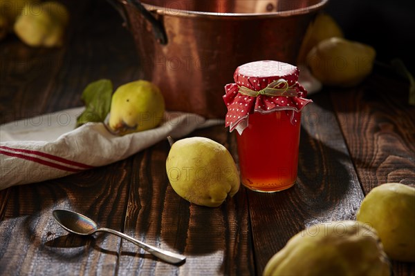 Quince jelly and fruit on wooden table