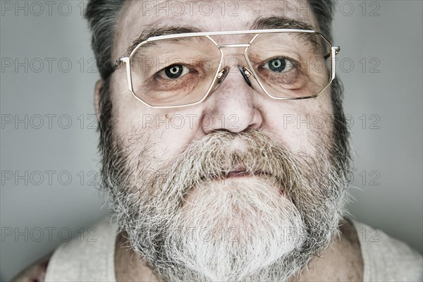 Senior with beard and glasses
