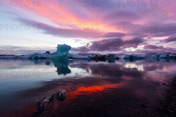 Blue iceberg in sunset