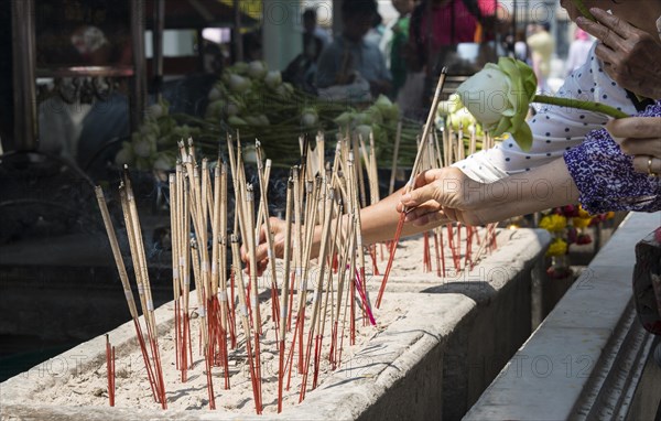 Believers lighting incense sticks