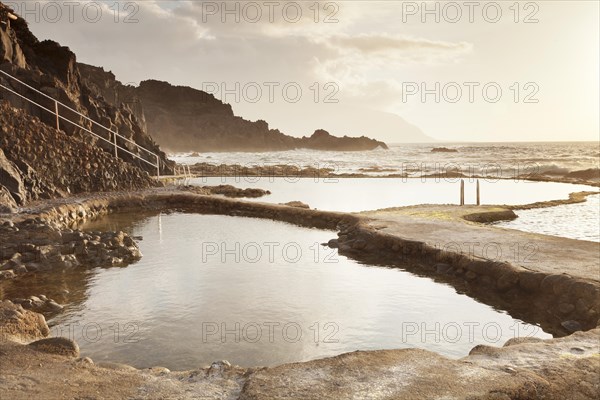 Natural swimming pool at sunset