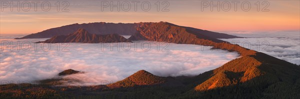 Cumbre Nueva and Cumbre Vieja mountains at sunset above clouds