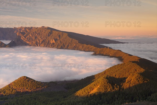 Cumbre Nueva and Cumbre Vieja mountains at sunset above clouds