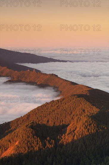 Mountain Cumbre Nueva above clouds at sunset