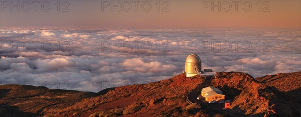 Observatory on the Roque de los Muchachos with clouds at sunset