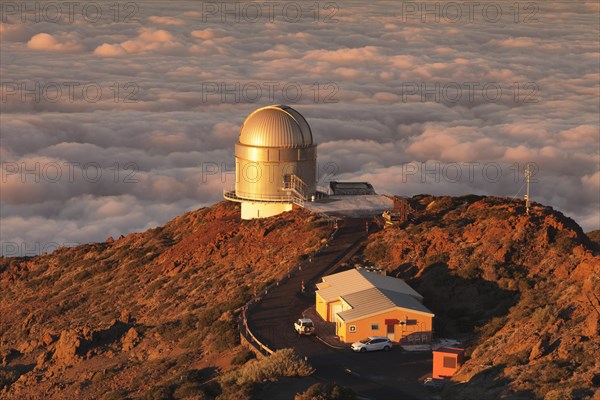 Observatory on the Roque de los Muchachos with clouds at sunset