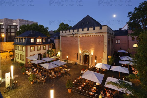 Restaurant terraces in front of the Heilig-Geist-Spital hospital