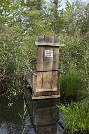 Small jetty with a sign