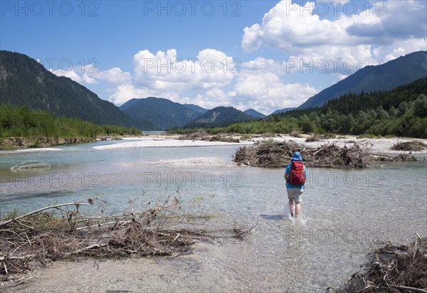 Woman walking in the riverbed of the Isar