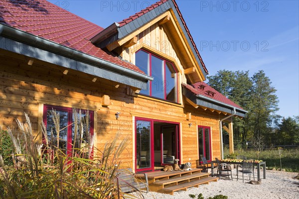 Modern log house made of larch with terrace