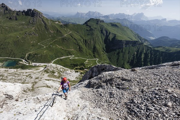 Mountaineer ascending to the Punta Serauta on the Via Ferrata Eterna in Marmolada