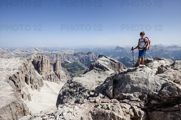 Mountaineer ascending of the Piz Boe on the Vallonsteig in the Sella group