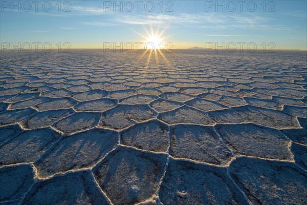 Honeycomb-structure with shadows on a salt lake at sunrise