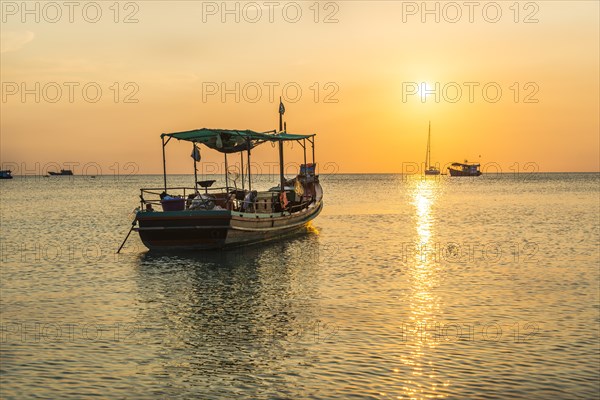 Fishing boat in the sea at sunset