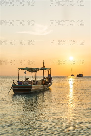 Fishing boat in the sea at sunset