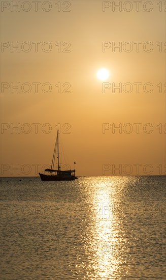 Sailboat in the sea at sunset