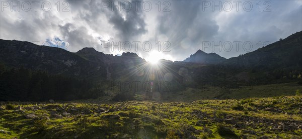 Sun shining over the mountain peak