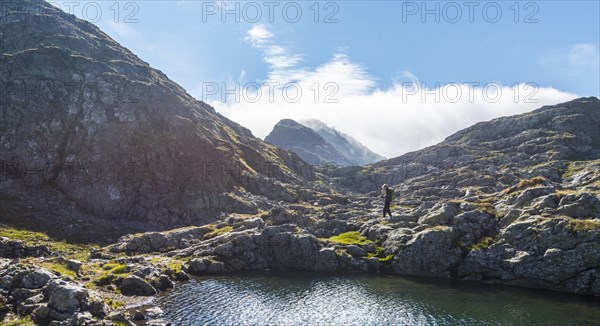 Hiker by a mountain lake