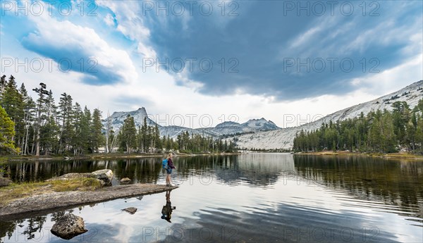 Hiker is standing on a lake