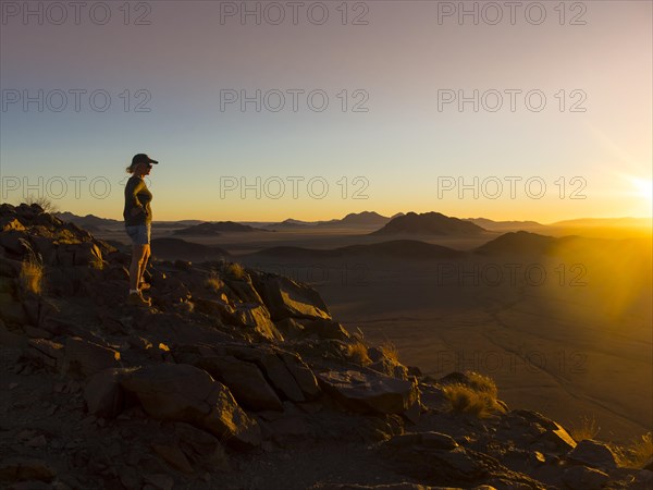 Woman at sunset overlooking Tsaris Mountains