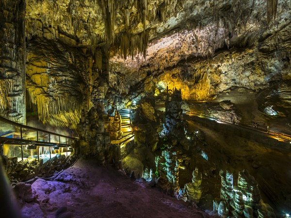 Stalactites in the colorfully lit cave Cuevas de Nerja