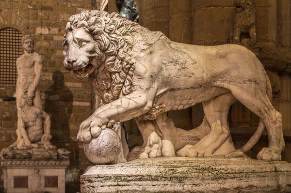 Sculpture of an ancient lion at night