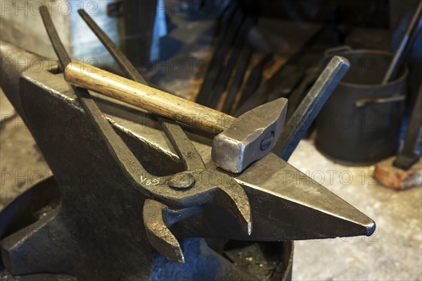 Old blacksmith's anvil with hammer and pincer