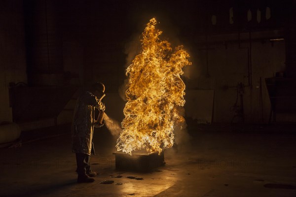 Firefighter extinguishes a heptane 2B-Pan fire with a 2-BTP extinguisher