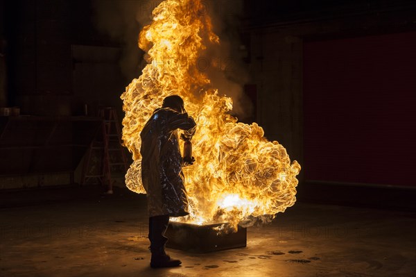 Firefighter extinguishes a heptane 2B-Pan fire with a 2-BTP extinguisher