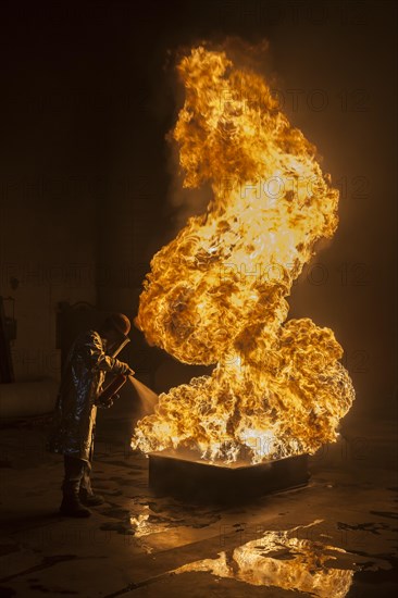 Firefighter extinguishes a heptane 5B pan fire with a 2-BTP extinguisher