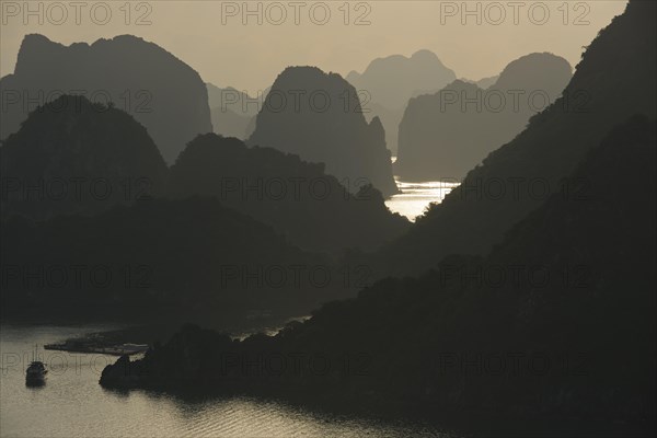 Boat on the water at sunset in the Ha Long Bay or Vinh Ha Long