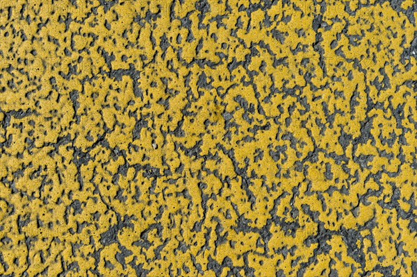 Yellow paint on asphalt