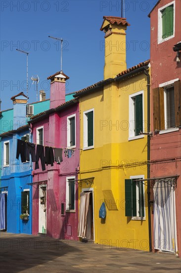 Clothesline between colourful houses