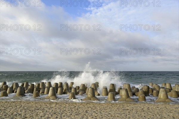 Waves break at concrete breakwaters