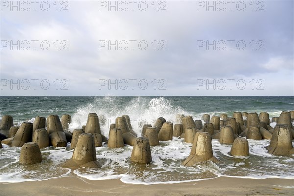 Waves break at concrete breakwaters