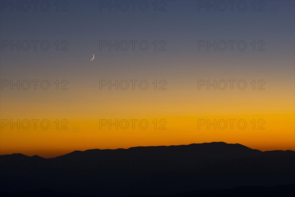 Sunset and crescent moon over the Sibillini Mountains