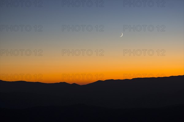 Sunset and crescent moon over the Sibillini Mountains