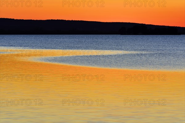 Red sunset reflected in water