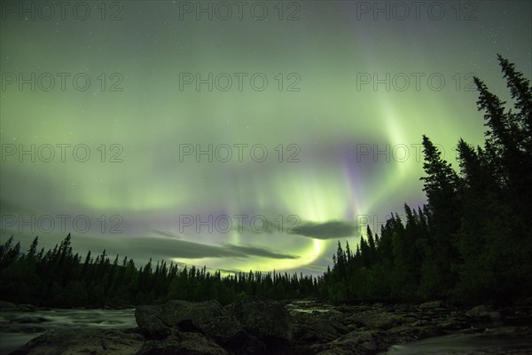 Northern Lights or Aurora Borealis over the river Gamajahka or Kamajakka
