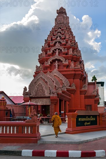 Monk in front of the Khmer-style City Pillar Lak Muang